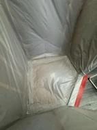 Taped plastic containment at the bathroom work-area entrance.