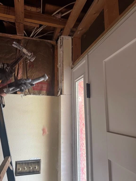 An open wall-and-ceiling area provides access to the affected construction.