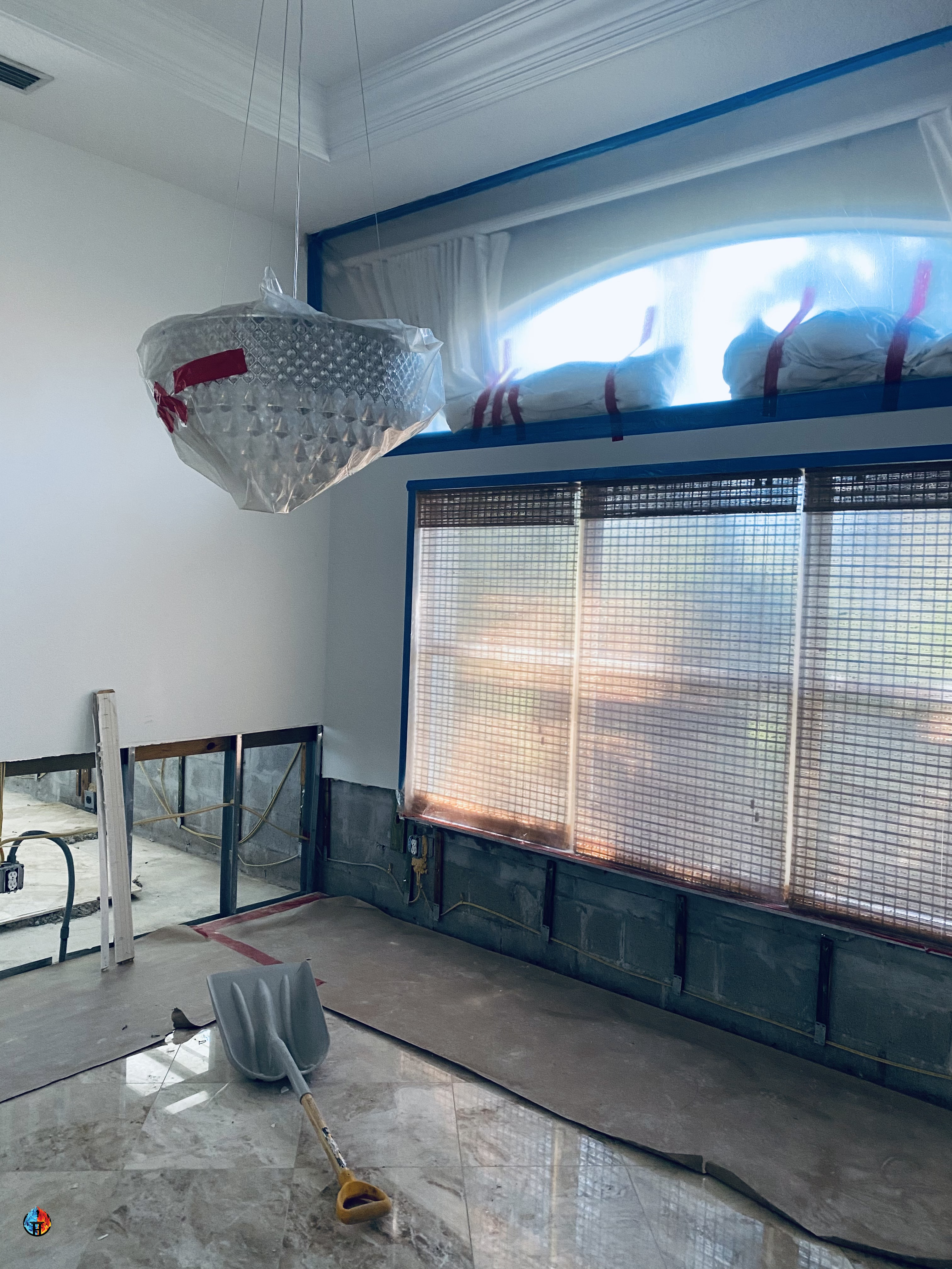 Room with opened lower wall framing beneath a protected window