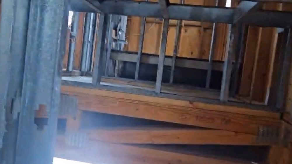 Exposed wood and metal framing viewed from below