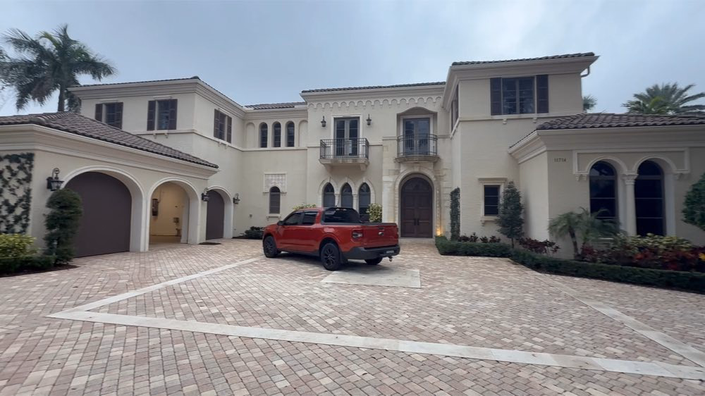 Large home with a paved courtyard