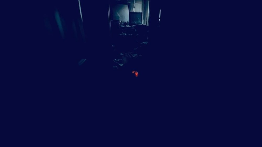 Dark room with an opening visible in the background