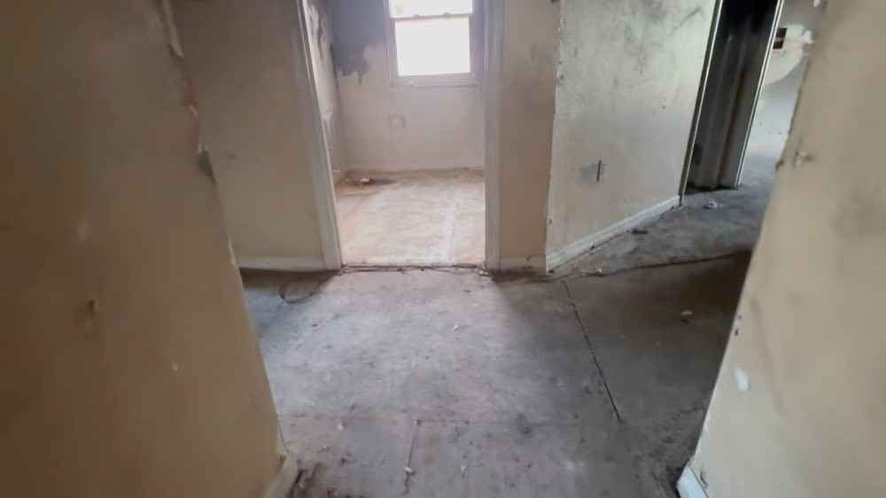 Stripped flooring connecting rooms during restoration