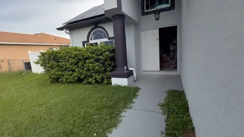 Walkway leading to an open residential entrance