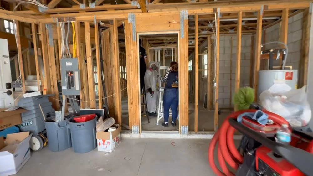 People and equipment inside a room with exposed framing