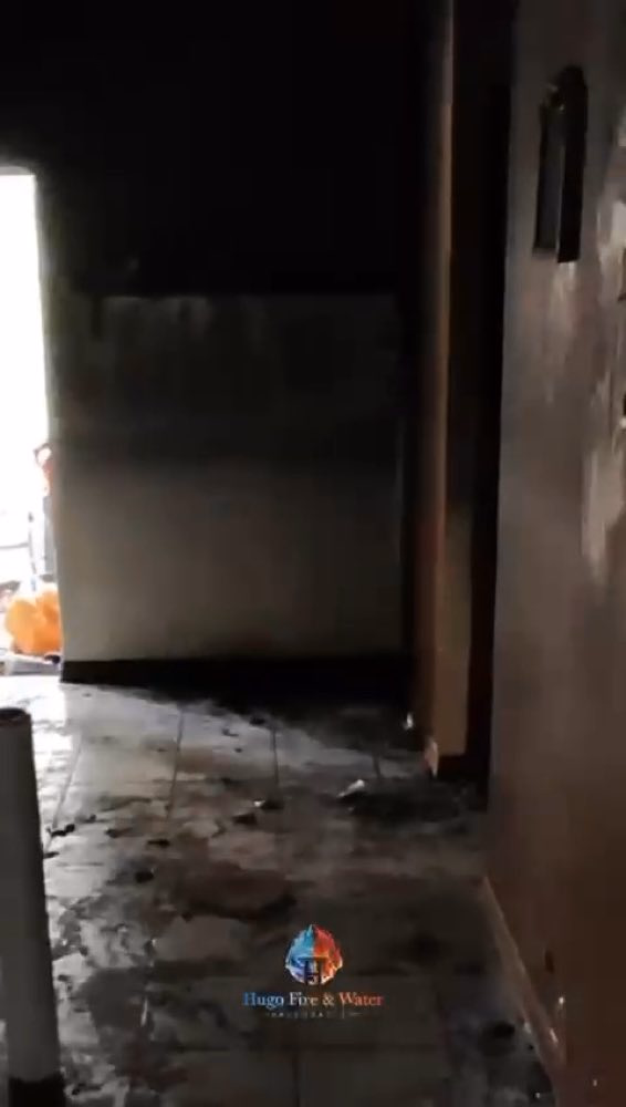 Soot-stained room with debris on the floor