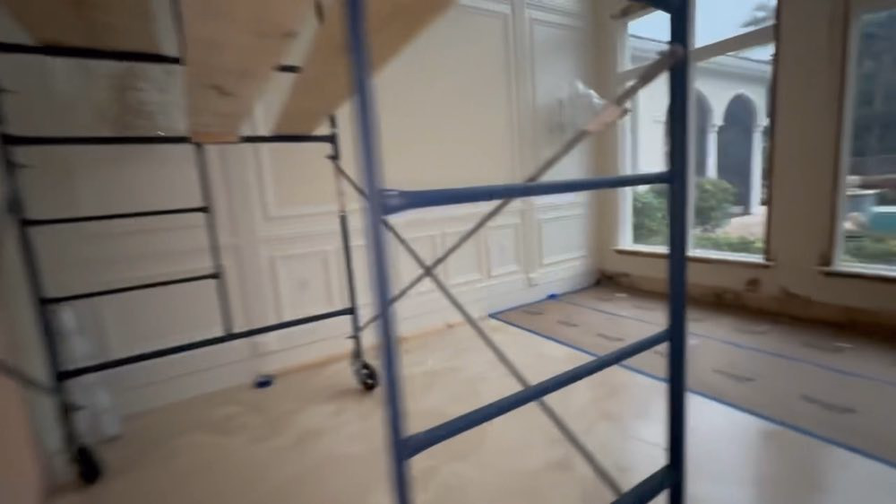 Scaffold legs on a protected floor beneath windows