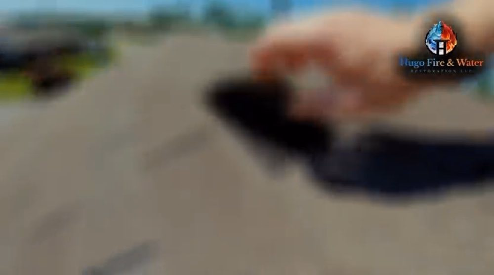 Close-up of a hand holding a dark object