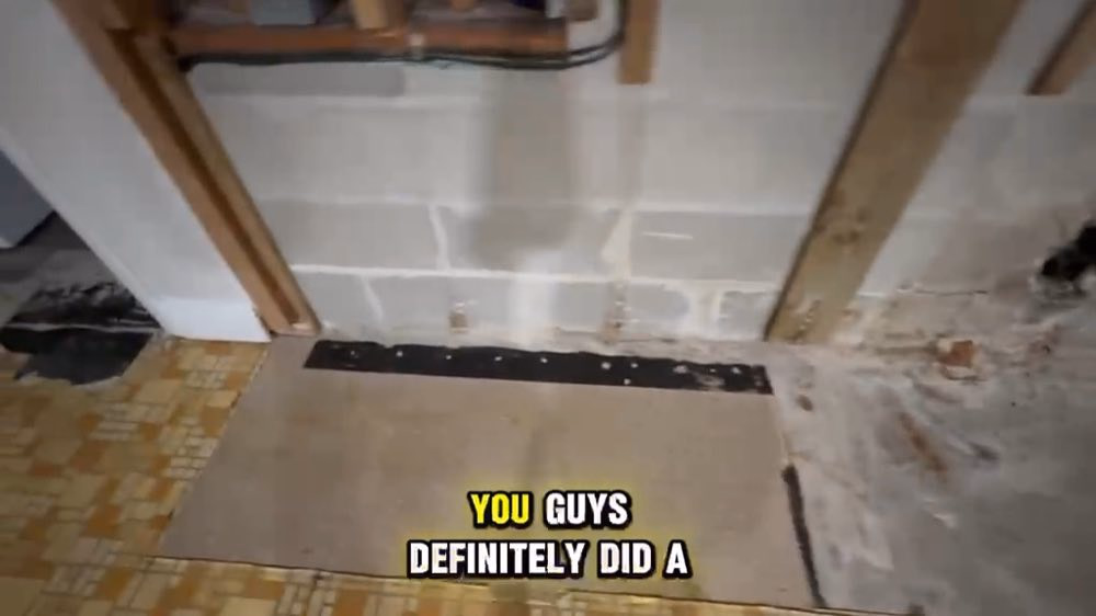 Exposed block wall beneath removed kitchen cabinets