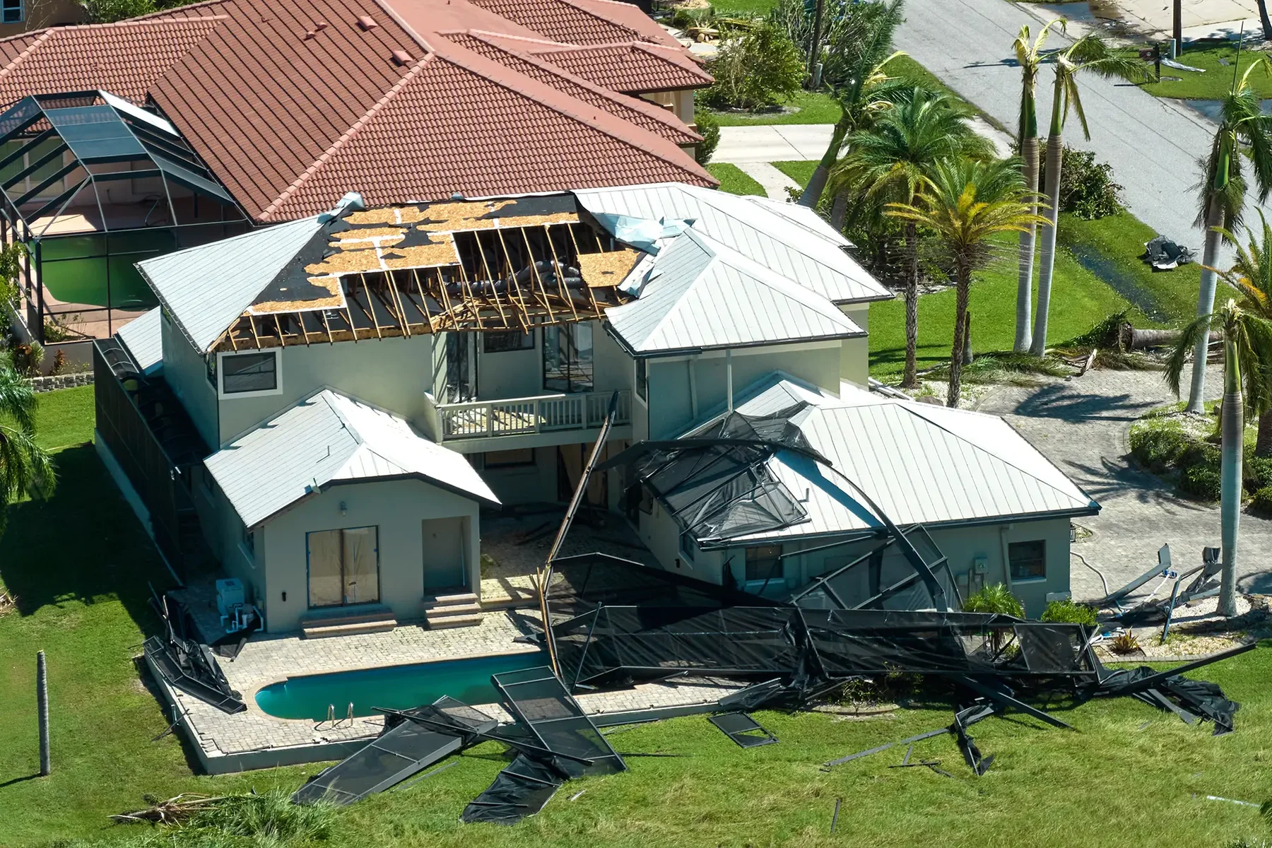 Aerial view of widespread roof damage after a severe storm