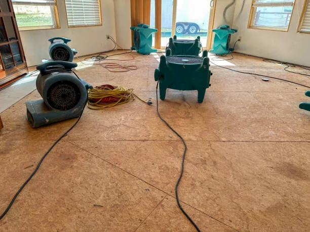 Drying equipment operating across a water-damaged floor