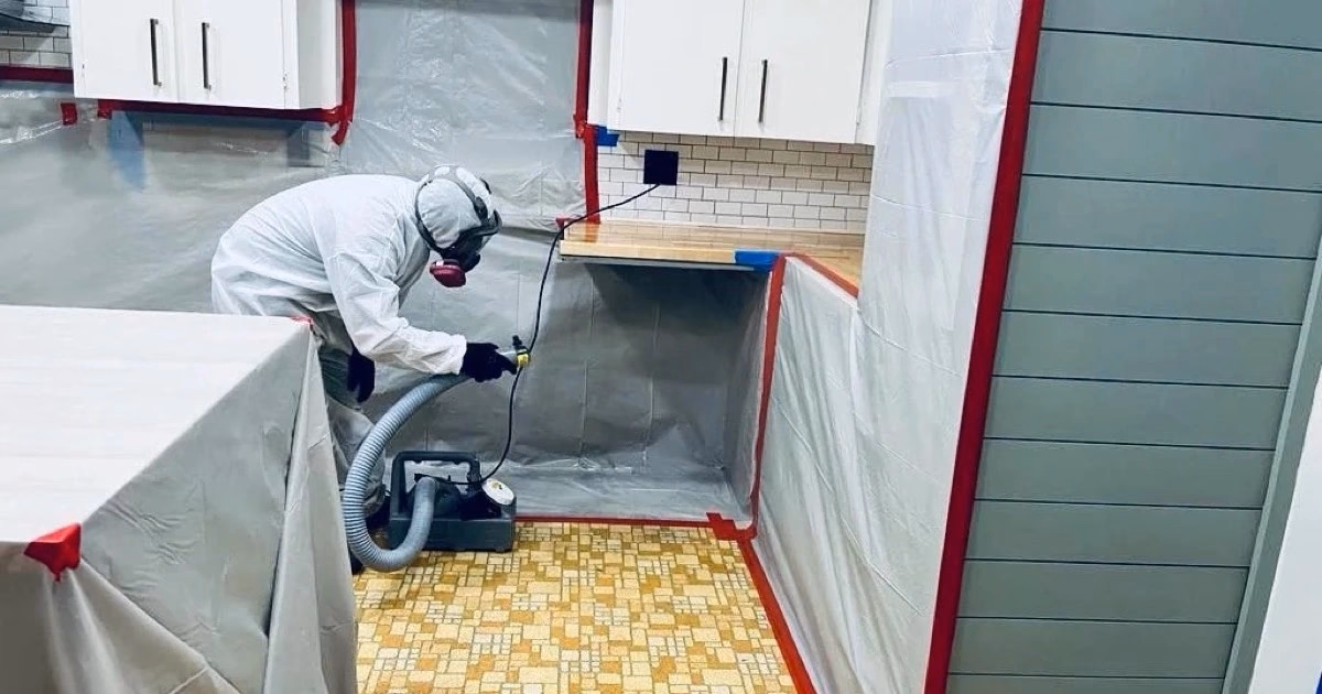 Láminas protectoras con trabajador limpiando la cocina detrás de ellas