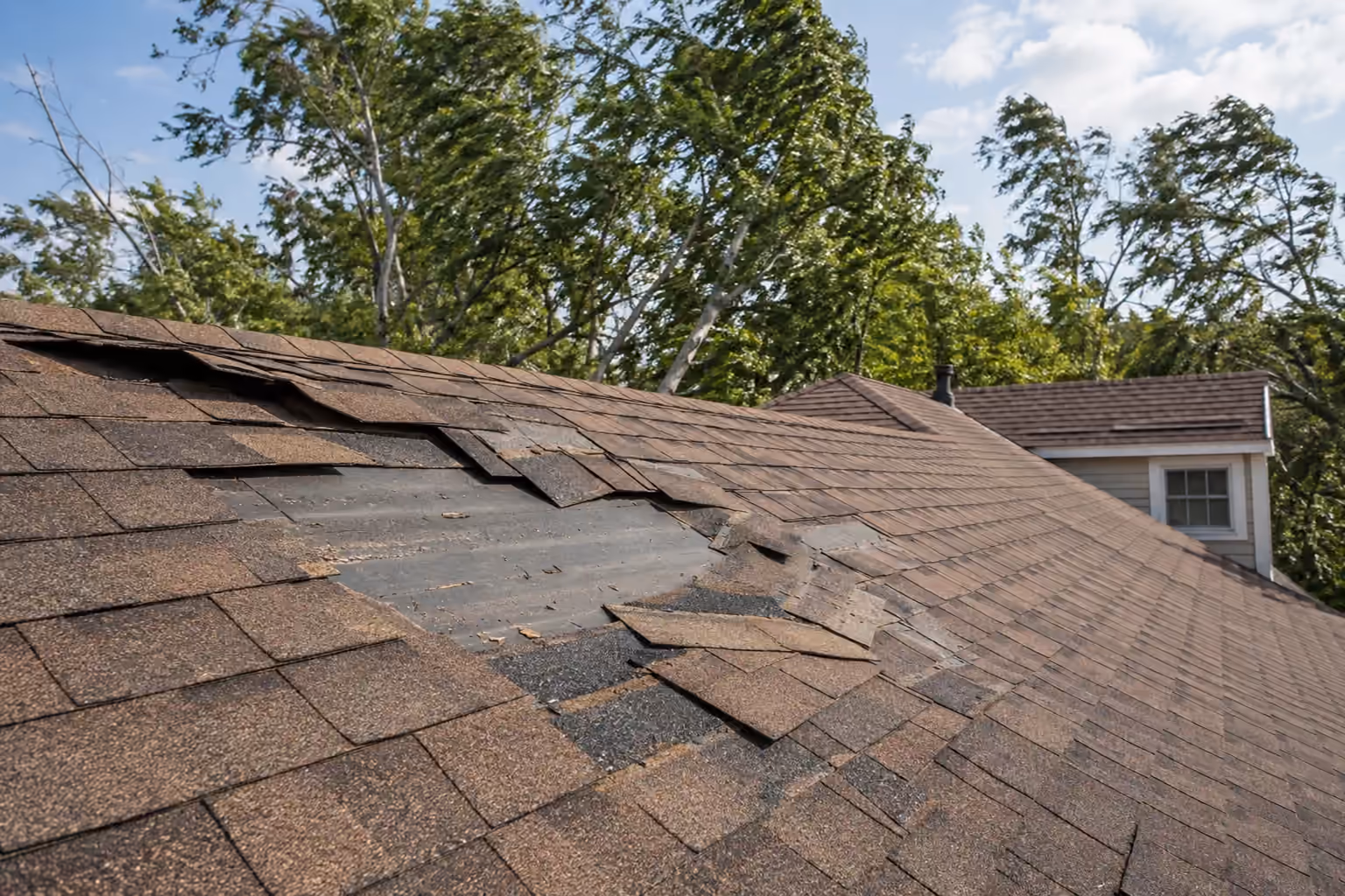 Illustration of lifted and missing roof shingles